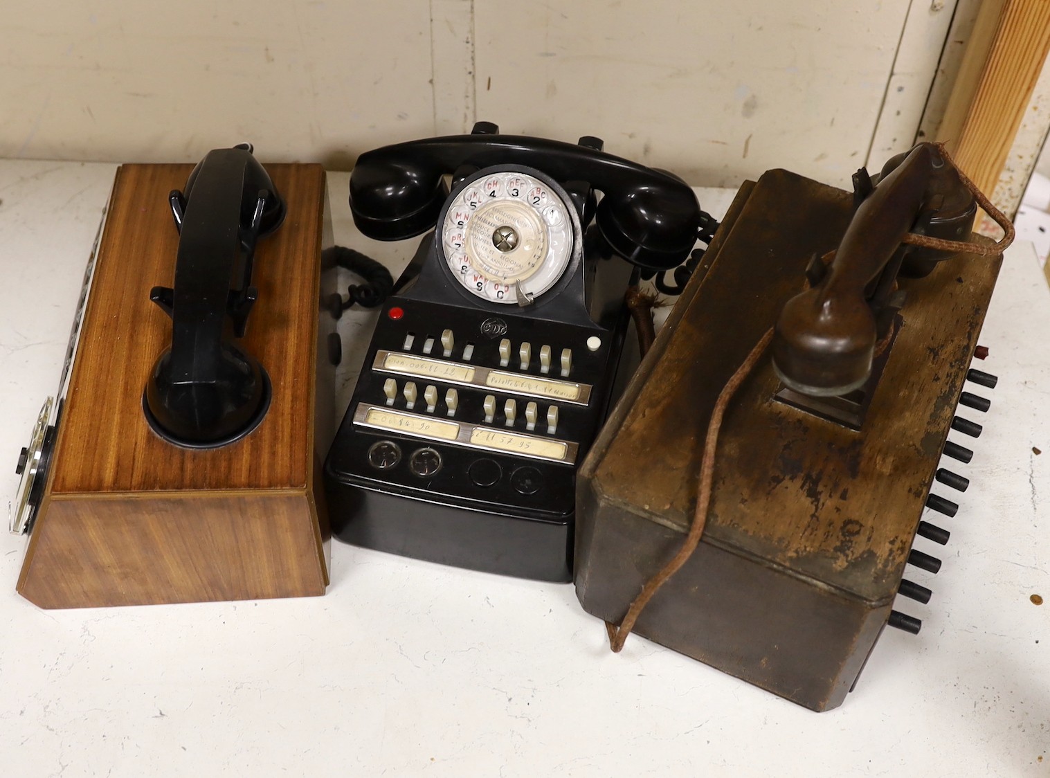 A 'switchboard' type Bakelite telephone together with two wooden cased examples (3)